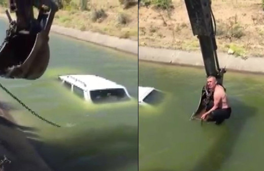 Aracıyla birlikte sulama kanalına düştü! Yardımına kepçe ile muhtar yetişti