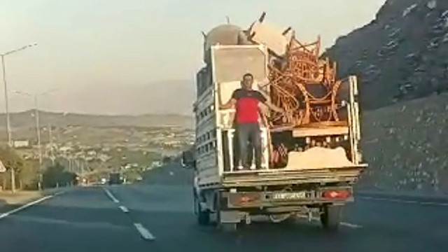 Eşya yüklü kamyonetin arkasında eşyalara tutundu ayakta yolculuk yaptı! Trafikteki o dakikalar dehşet saçtı - Resim: 1
